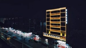 A modern hotel with a grid-like facade and illuminated windows at night. - Xianglong Boutique Hotel (Guangzhou North Railway Station Huacheng Road Subway Station) (Guangzhou)