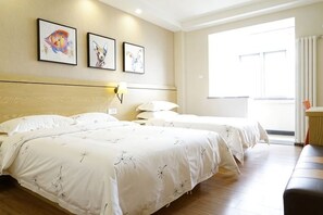 A hotel room with two beds, a wooden floor, a large window, and wall-mounted artwork. - Guijing Business Hotel (Beijing)