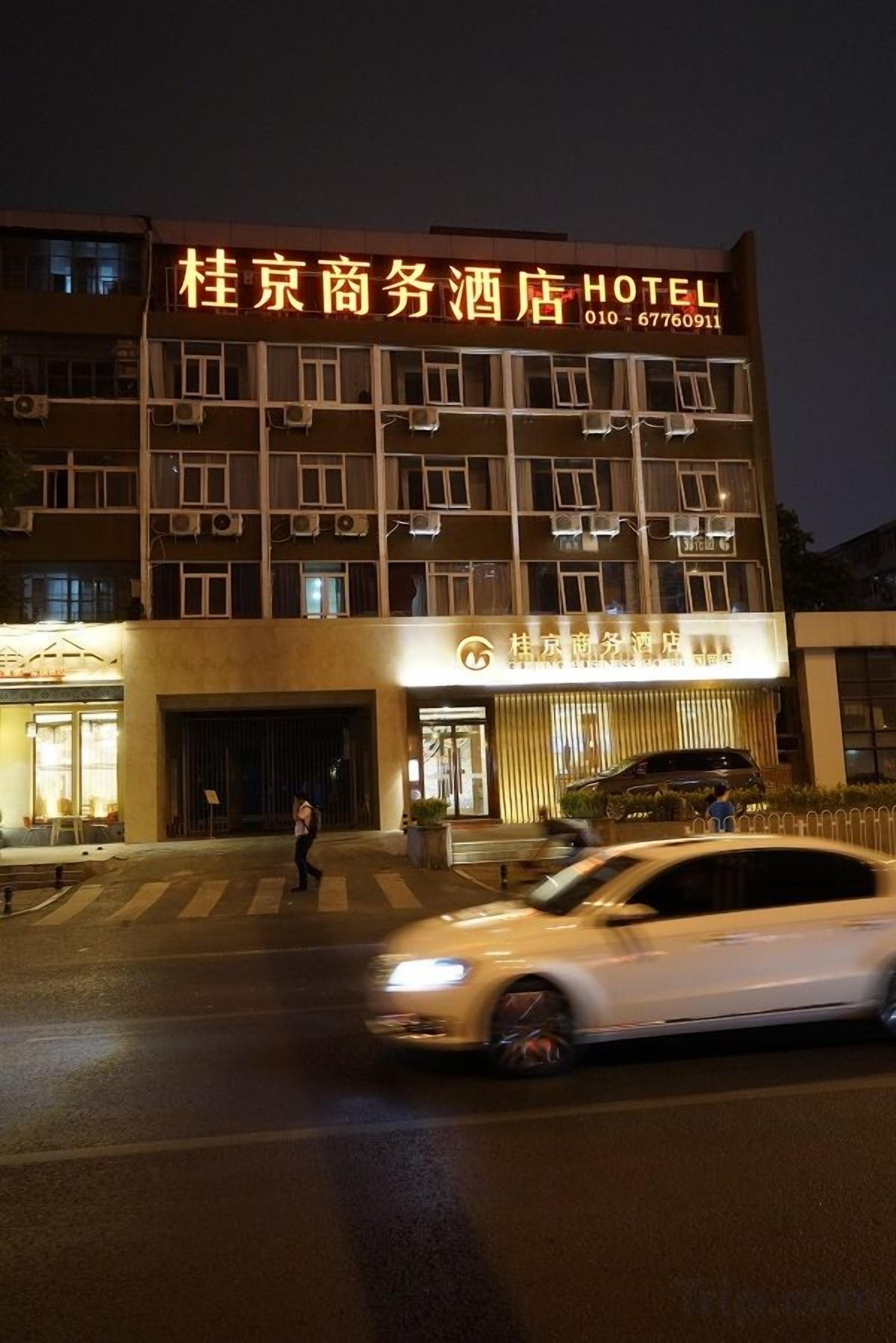 Un hotel con un cartel llamativo que muestra su nombre y número de contacto.