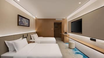 Une chambre d’hôtel avec deux lits, une télévision, un mur recouvert de panneaux en bois et une porte donnant accès à la salle de bain.