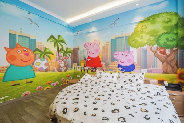 A bedroom with a cityscape mural, a bed with a leopard print bedspread, and a nightstand with a lamp.