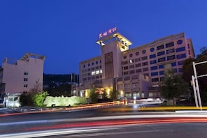 A multi-story hotel with a prominent entrance and a large sign above the main entrance.