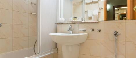 A bathroom with a bathtub, sink, and toilet.