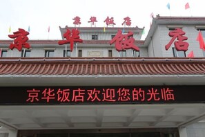 A hotel sign with Chinese characters and a welcome message.
