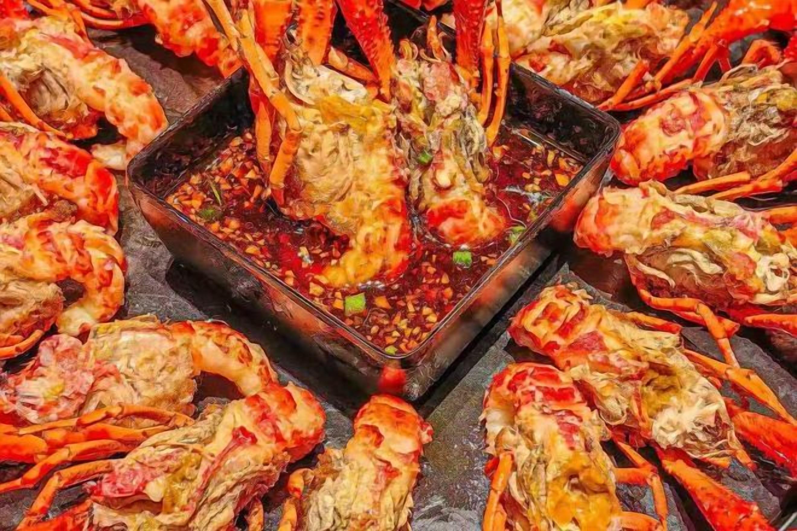 A variety of seafood, including lobsters and crabs, arranged on a grill.