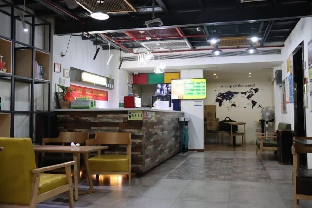 A restaurant with wooden furniture, a counter, and a world map on the wall.