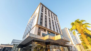 A modern hotel with a prominent glass facade, multiple floors, and a rooftop terrace. - Teymur Continental Hotel (Gaziantep)