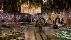 A banquet hall with tables set for a formal event, featuring chandeliers and floral decorations. - Teymur Continental Hotel (Gaziantep)