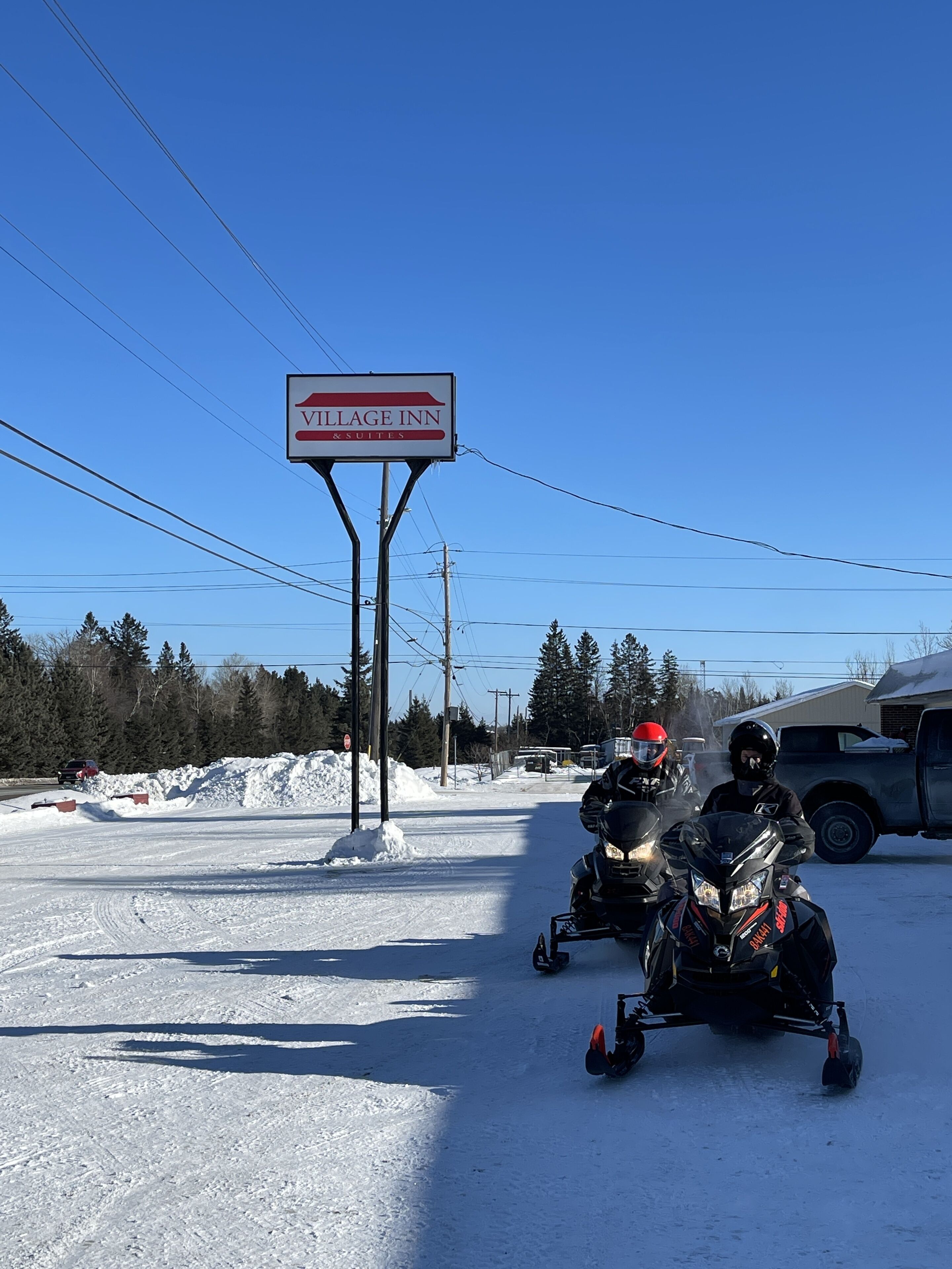 A sign for VILLAGE INN & SUITES.
