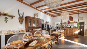 Ein reichhaltiges Buffet mit verschiedenen Speisen und einer Bar im Hintergrund.