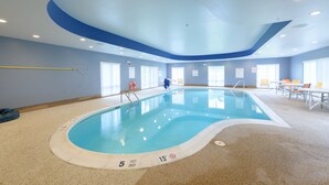 An indoor swimming pool with a 5 feet deep and 15 feet long marking, surrounded by a beige floor and blue walls. - Holiday Inn Express & Suites Jamestown by IHG (Jamestown)