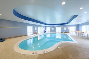 An indoor swimming pool with a 5 feet deep and 15 feet long marking, surrounded by a beige floor and blue walls. - Holiday Inn Express & Suites Jamestown by IHG (Jamestown)