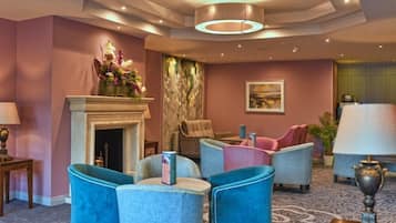 Relax in our inviting lobby with plush seating, a fireplace, and elegant chandelier.