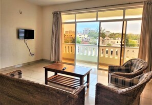Basic Apartment, Pool View | Living area | Flat-screen TV - Nightingale Apartments (Mombasa)