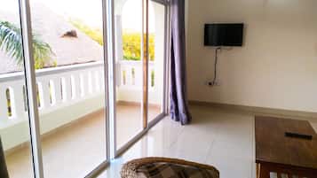 Basic Apartment, Pool View | Living area | Flat-screen TV