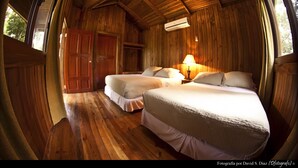 A wooden cabin with two beds, a wardrobe, and a lamp. - Pulhapanzak Waterfalls Cabins (San Francisco de Yojoa)
