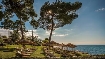 On the beach, sun-loungers, beach umbrellas
