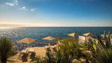 On the beach, sun loungers, beach umbrellas