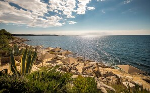On the beach, sun loungers, beach umbrellas