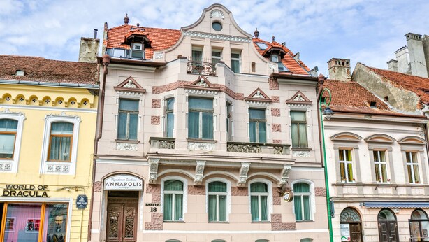 A historic building with ornate architectural details, a prominent entrance, and a sign indicating it is the "Resilience Central." - Residence Central Annapolis (Brasov)