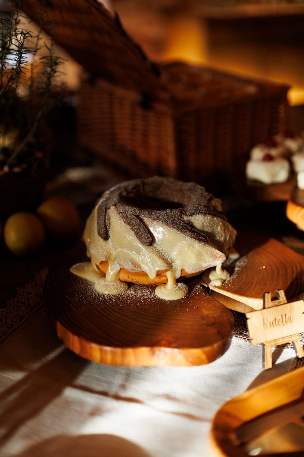 A dessert with a chocolate topping, a wooden serving board, and a sign labeled 'Nutella'.