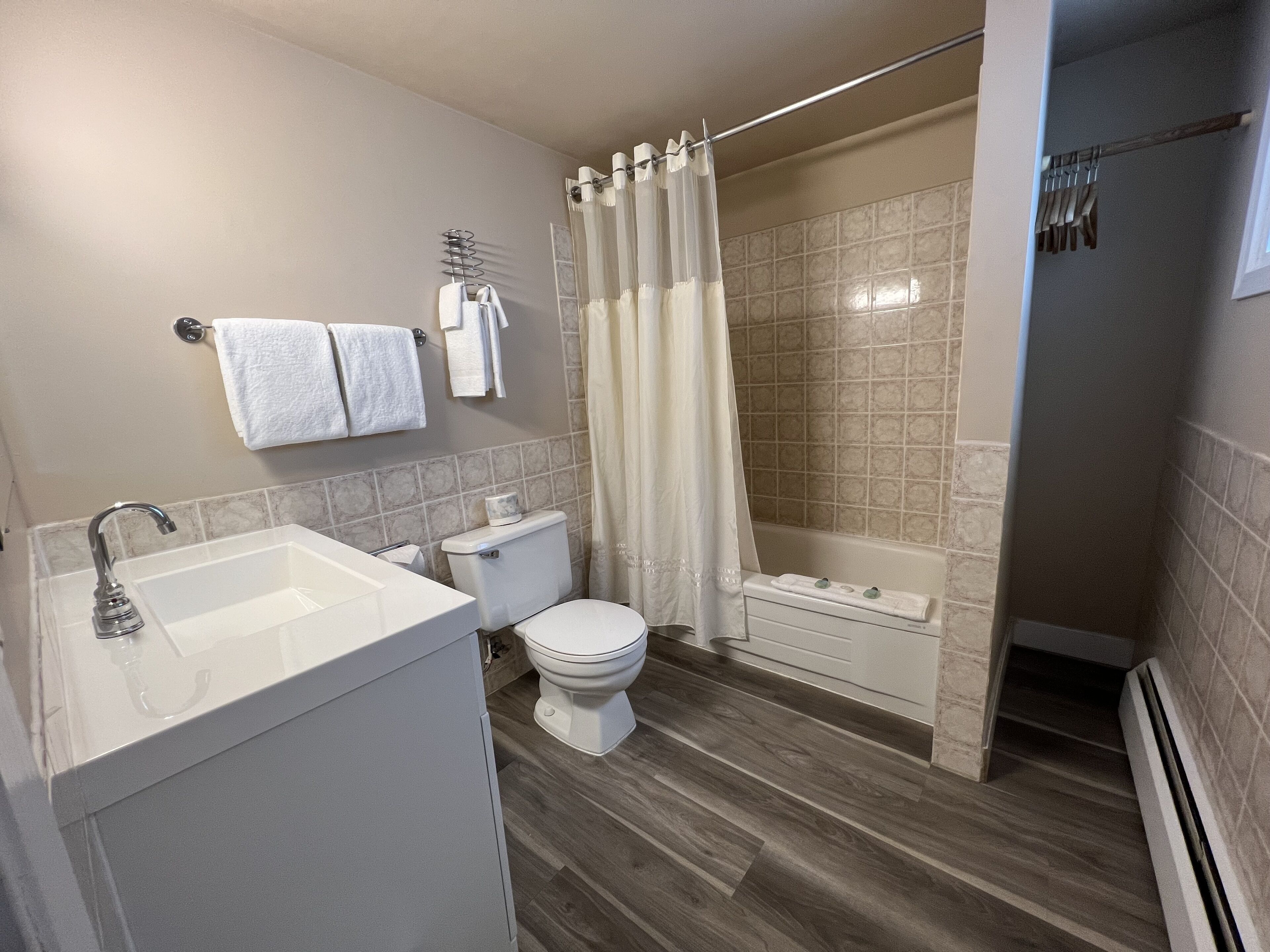 A modern bathroom with a sink, toilet, and shower area.