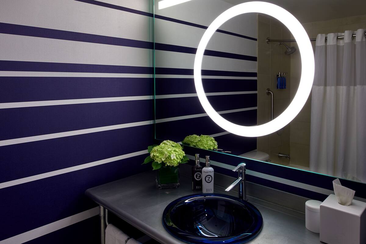 designer toiletries, hair dryer, towels, soap