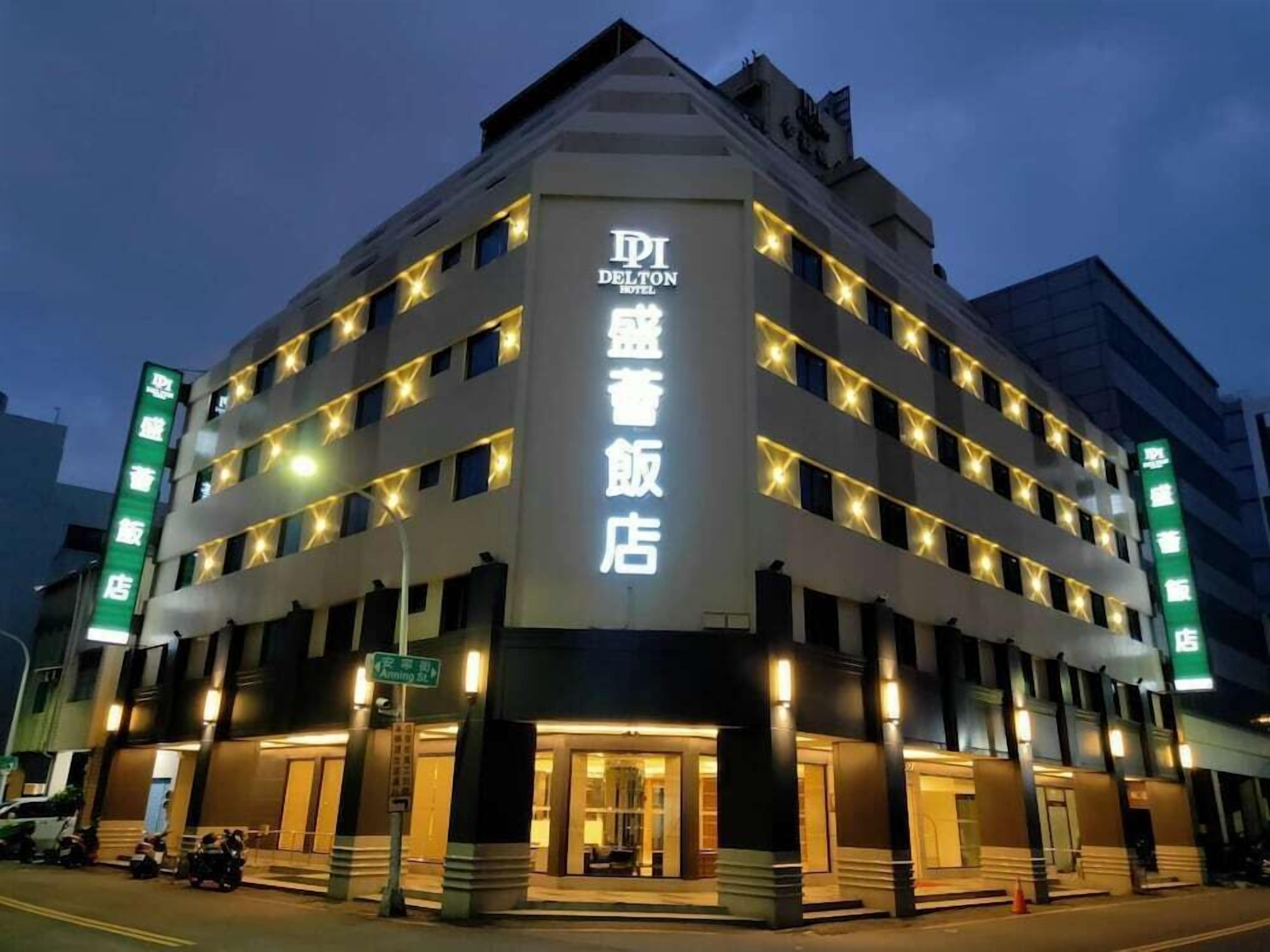A multi-story hotel with a prominent sign in both English and another language, indicating it is a Delton Hotel.