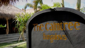 A sign for 'The CalmTree Bungalows' with a tropical backdrop. - The Calmtree Bungalows (Canggu)