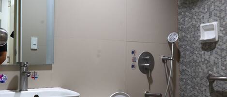 A bathroom with a toilet, sink, and shower.