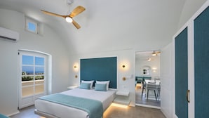 A modern bedroom with a large bed, a ceiling fan, a view through a door, and a small balcony. - Sienna Eco Resort (Santorini)