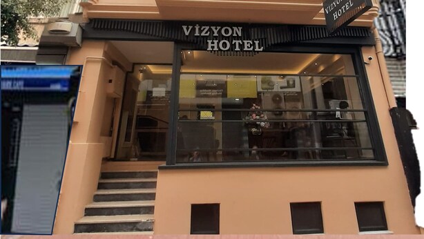 The Vizyon Hotel building facade with a signboard, windows, and a staircase leading to the entrance. -  Vizyon Hotel - Old City (Istanbul)