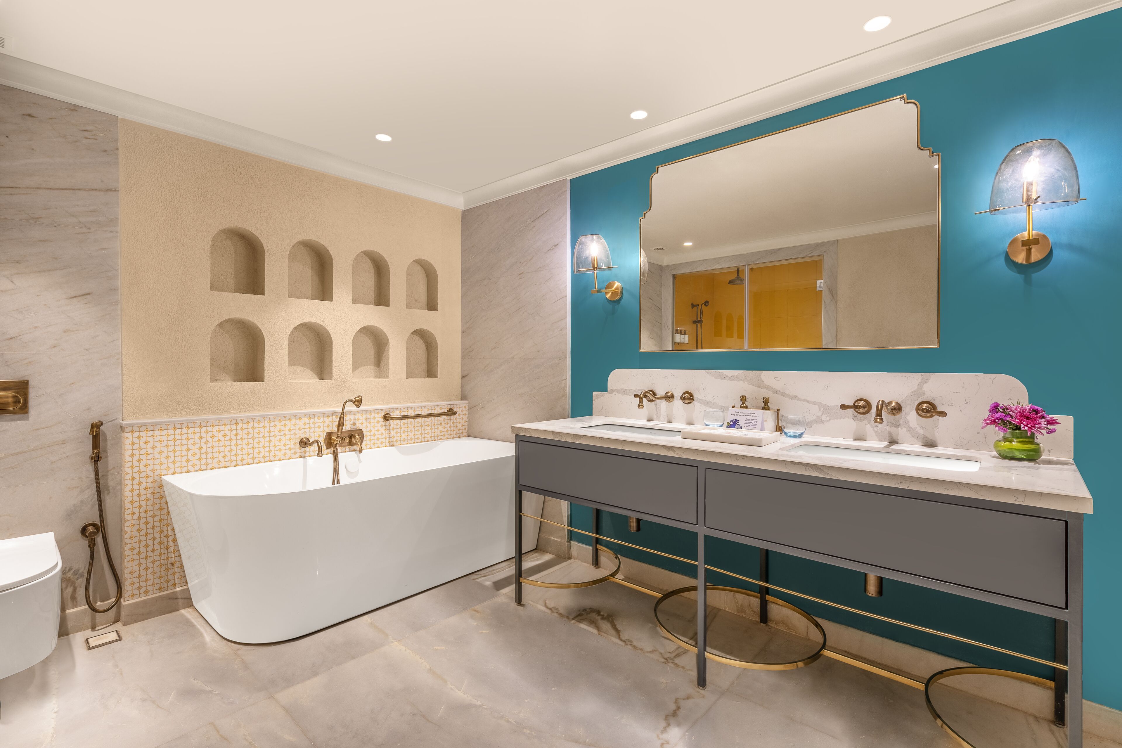A modern bathroom with a freestanding bathtub, a double sink vanity, and a large mirror.