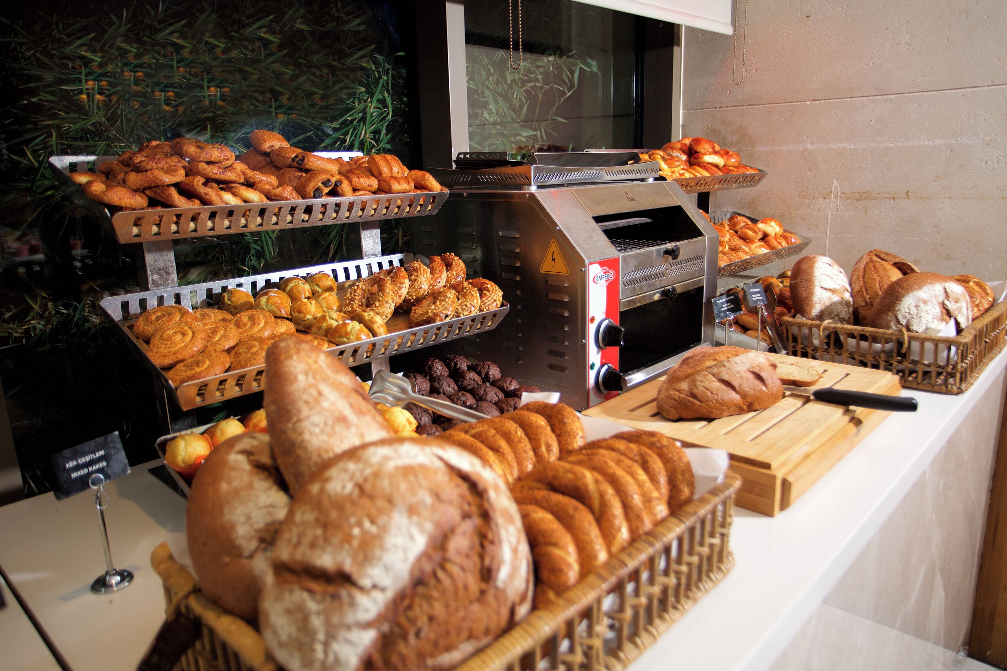 A bakery display with various breads and pastries.