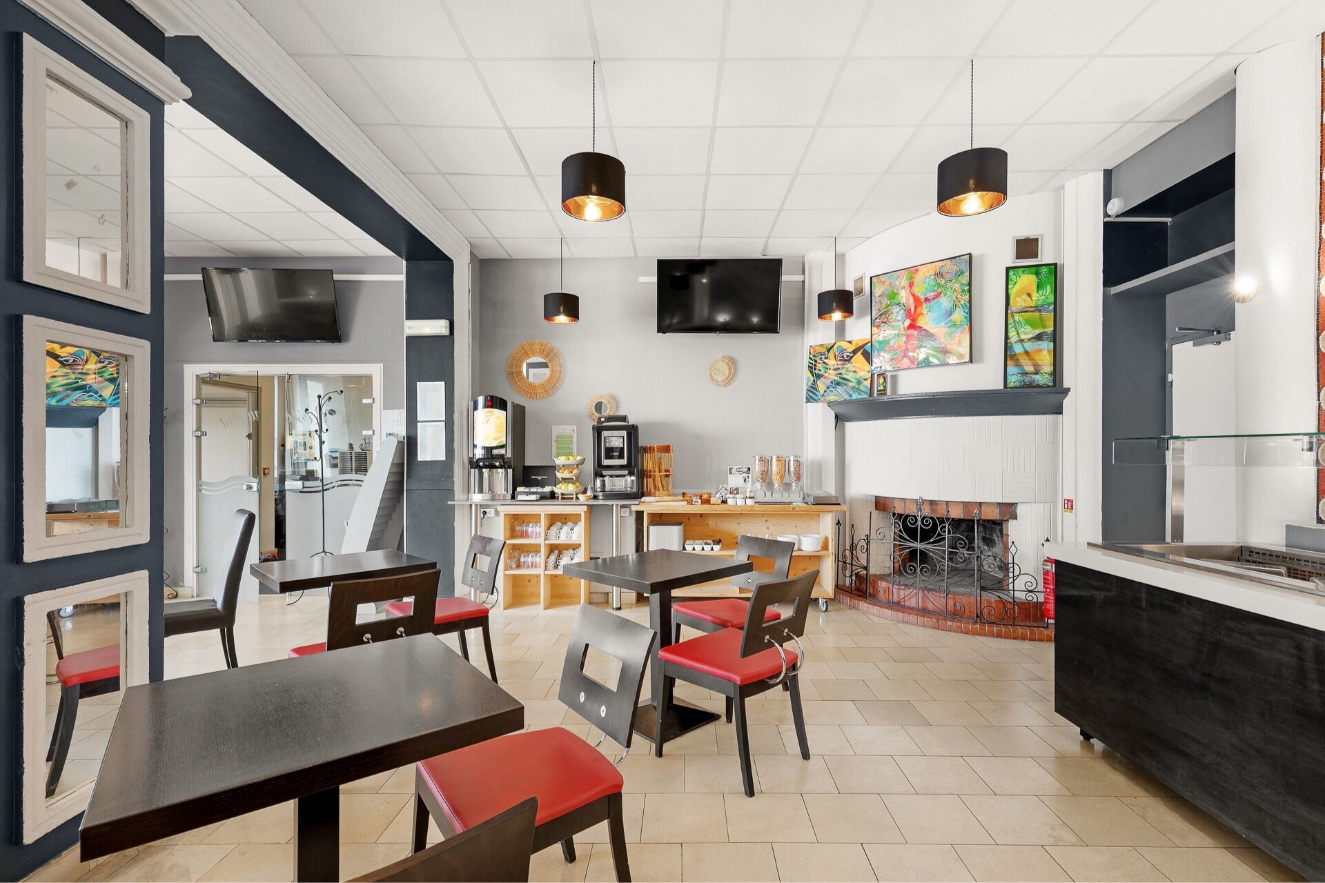 Un restaurante moderno con chimenea, zona de comedor y barra de café.