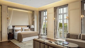 A modern hotel room with a large bed, a sofa, a glass coffee table, and a balcony with a view. - Kemer Country Hotel (Eyup)