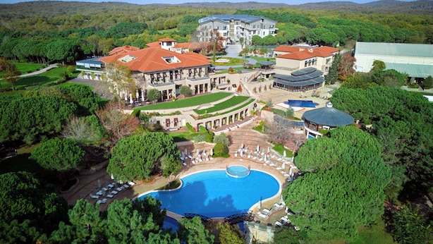 A large resort with multiple buildings, a central pool area, and surrounding lush greenery. - Kemer Country Hotel (Eyup)
