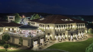 A large, multi-story building with a courtyard, outdoor seating area, and a restaurant. - Kemer Country Hotel (Eyup)