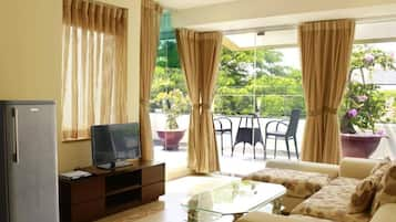 Diamond One Bedroom Apartment | Living room | 32-inch LCD TV with satellite channels, TV