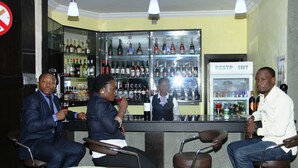 A bar area with seating and a refrigerated display case labeled "RESTP INT". - Jades Hotel (Abuja)