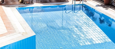 Seasonal outdoor pool, pool umbrellas, pool loungers