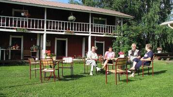 Enjoy outdoor dining and social gatherings on the spacious lawn, surrounded by lush greenery.