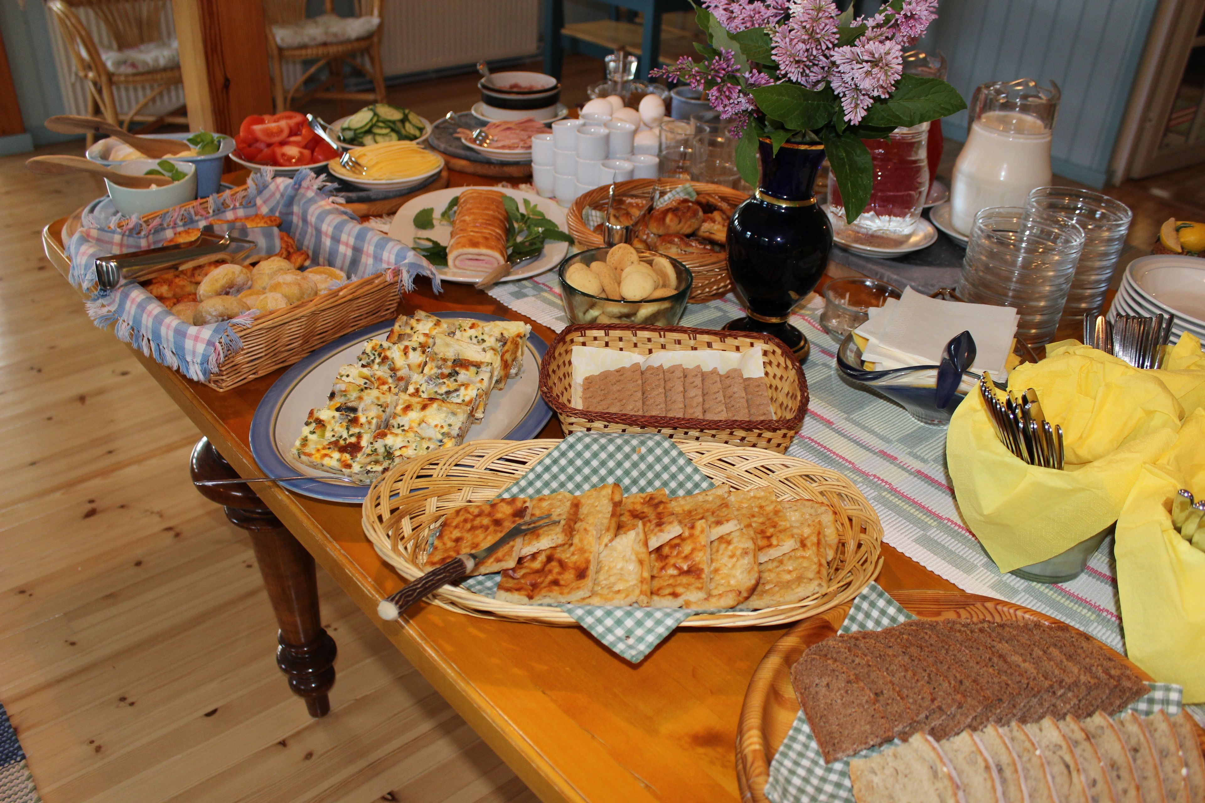 A buffet table with various food items and utensils.
