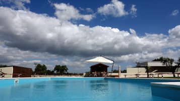 Seasonal outdoor pool, open 9 AM to 6 PM, pool umbrellas, pool loungers