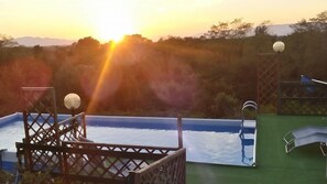 Seasonal outdoor pool, open 8:00 AM to 7:30 PM, pool umbrellas