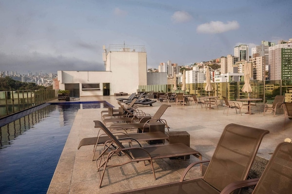 Outdoor pool, open 8:00 AM to 10:00 PM, pool loungers