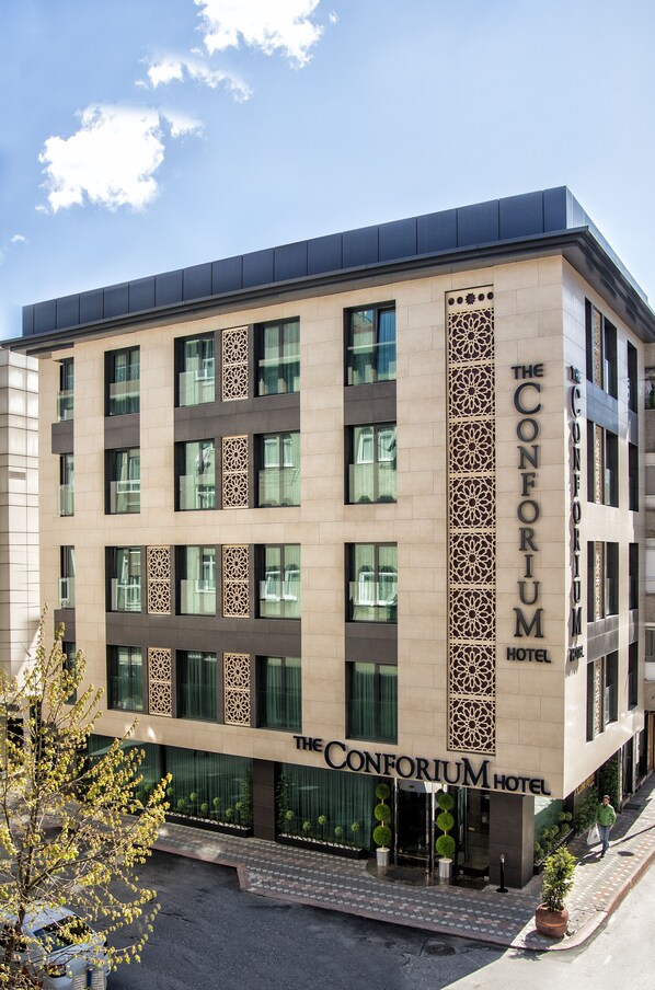 A modern hotel with a prominent facade, multiple windows, and a decorative vertical panel. - The Conforium Hotel (Istanbul)