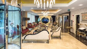 A luxurious lobby with ornate chandeliers, plush seating, and a grand piano. - The Conforium Hotel (Istanbul)