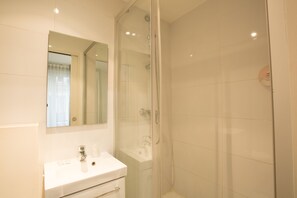 Habitación doble | Baño | Ducha, secador de pelo y toallas