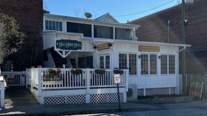 A two-story building with a sign reading "Hall House Hotel" and "Bourbon Street Grille". - Hall House Hotel (Dahlonega)